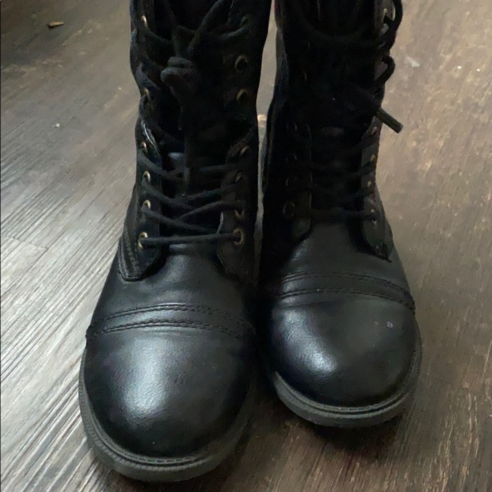 Black combat boots .